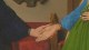 Two people are holding hands; one person wears a dark sleeve, the other wears a blue sleeve with a green garment. The setting appears to be indoors with a red chair in the background.